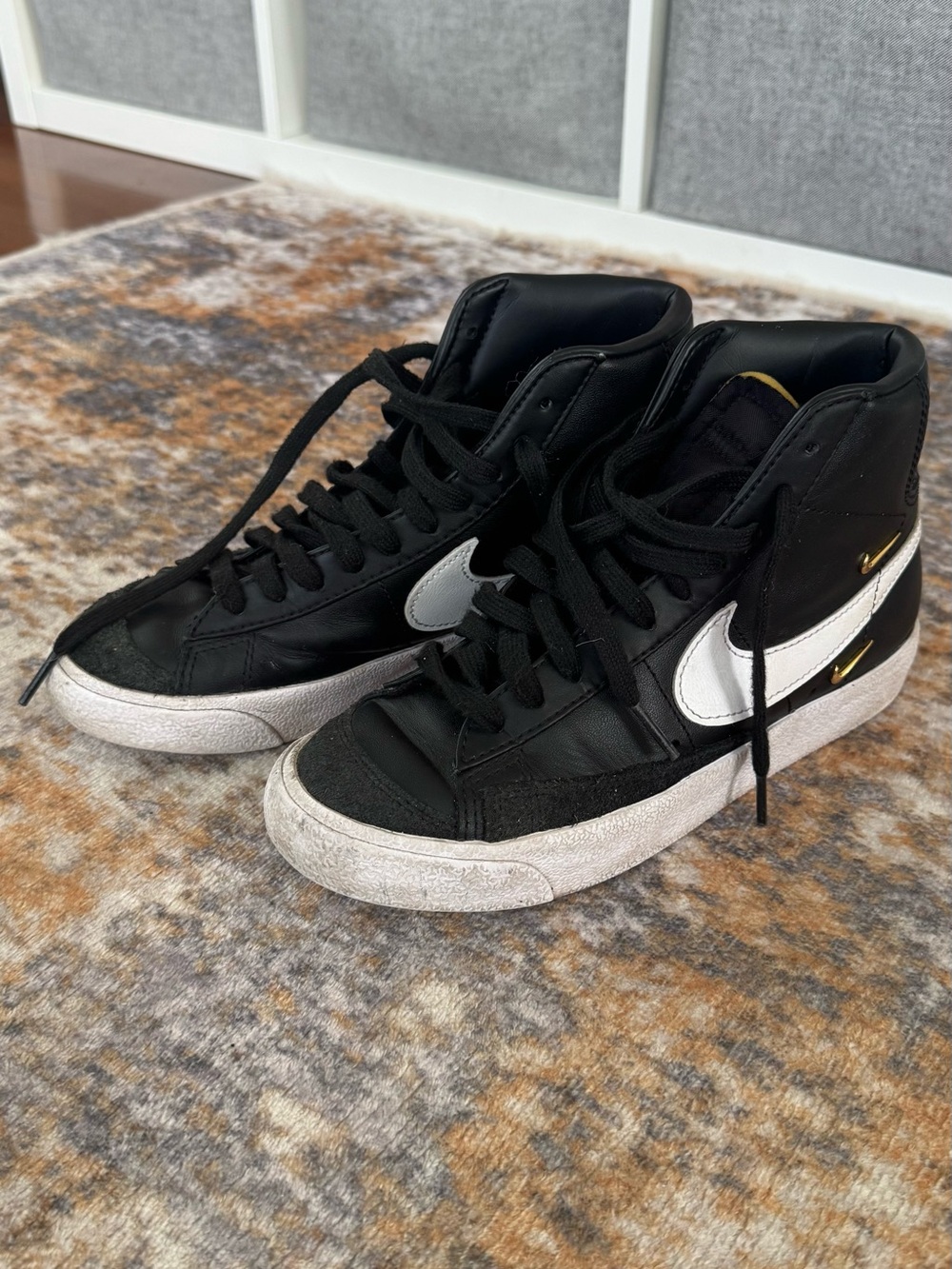 Nike Black High-Top Sneakers with White Swoosh and Gold Accents